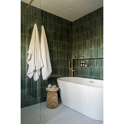 We love the different shades of green reflected in the tiles of this family bathroom. The touches of brass create the perfect contrast. We stole just enough space from the landing to allow for a decent sized bath bath, nestled perfectly into the space created. We did find ourselves measuring, remeasuring and measuring again on this one 😅